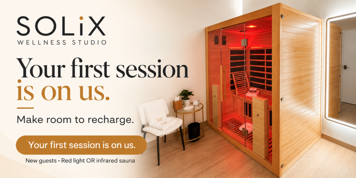 A wooden infrared sauna in a private SOLiX room, beside a chair and mirror. Campaign text: Your first session is on us. Make room to recharge.